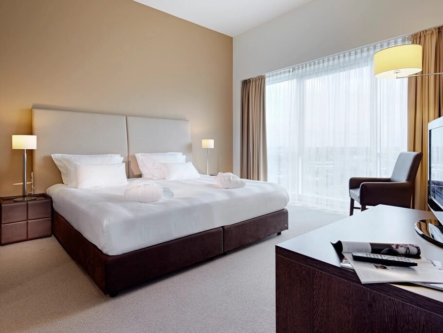 A serviced apartment bedroom made up for the next guest